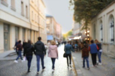Photo of Blurred view of people walking on city street