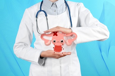 Doctor demonstrating virtual image of infected female reproductive system on blue background, closeup. Vaginal candidiasis