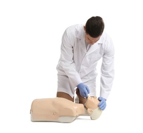 Doctor in uniform practicing first aid on mannequin against white background