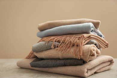 Photo of Stack of cashmere clothes on stone table