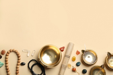 Flat lay composition with golden singing bowl on beige background, space for text. Sound healing