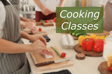 Cooking classes. Blurred view of people preparing meat in kitchen, closeup