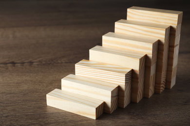 Steps made with blocks on wooden table. Career ladder