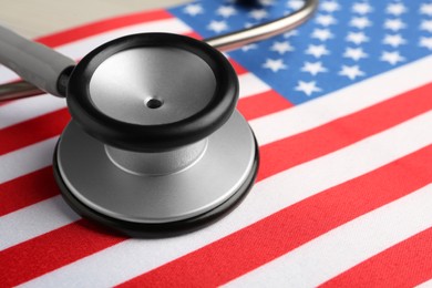 Photo of Stethoscope on American flag, closeup. USA medicine and health care concept