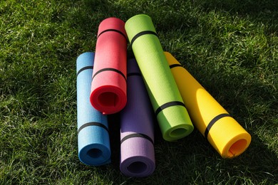 Bright exercise  mats on fresh green grass outdoors