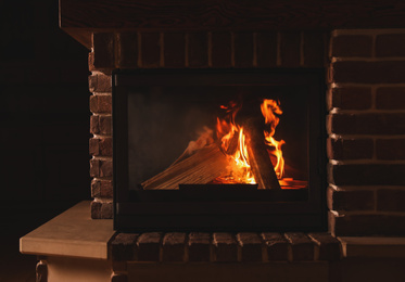 Fireplace with burning wood indoors. Winter vacation
