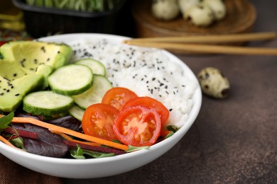 Photo of Delicious poke bowl with vegetables, avocado and mesclun on textured table, closeup