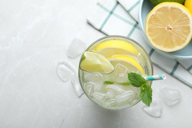 Photo of Flat lay composition of delicious lemonade with soda water and mint on light grey table, space for text. Fresh summer cocktail