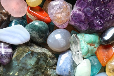 Photo of Different beautiful gemstones as background, top view