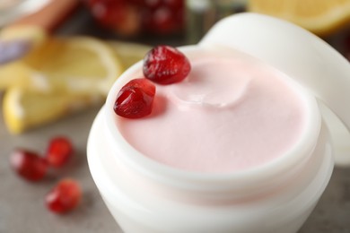 Photo of Natural facial mask and pomegranate seeds on table, closeup