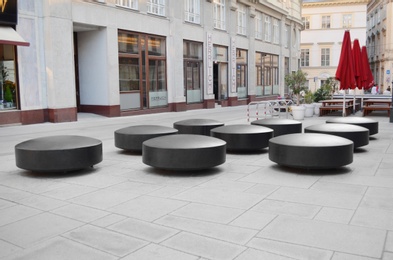 VIENNA, AUSTRIA - JUNE 18, 2018: Small circular benches on city street