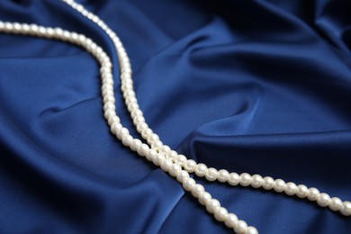 Beautiful pearls on delicate dark blue silk