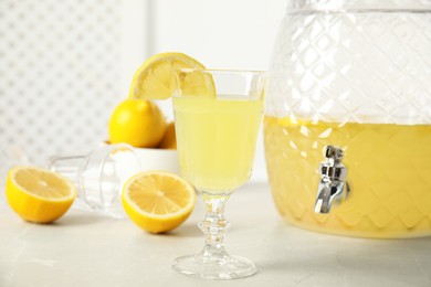 Delicious refreshing lemonade and fruits on light table