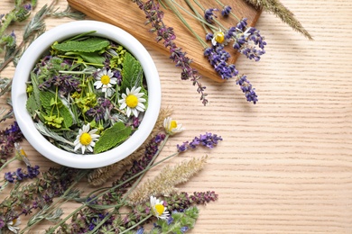 Flat lay composition with healing herbs on wooden table