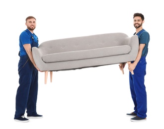 Young workers carrying sofa isolated on white. Moving service