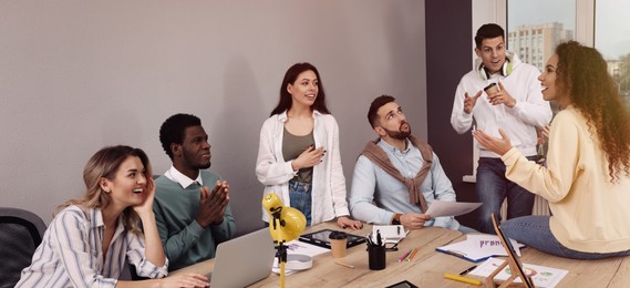 Image of Group of coworkers together in office. Banner design