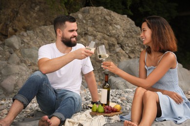 happy young couple having picnic on beach