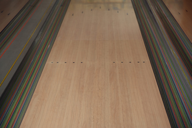 Empty wooden alley lane in modern bowling club