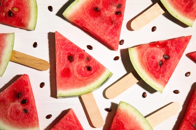 Slices of ripe watermelon on white wooden table, flat lay