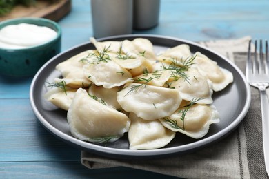 Delicious dumplings on turquoise wooden table, closeup