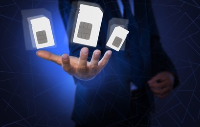 Man demonstrating SIM cards of different sizes on color background, closeup 