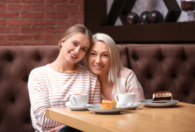 Mother and her adult daughter spending time together in cafe