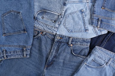 Photo of Variety of jeans with different pockets as background, top view