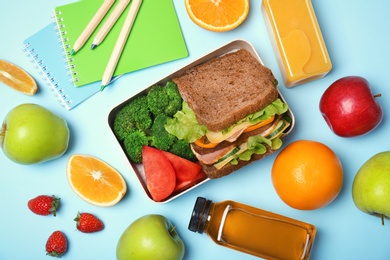 Flat lay composition with healthy food for school child on color background