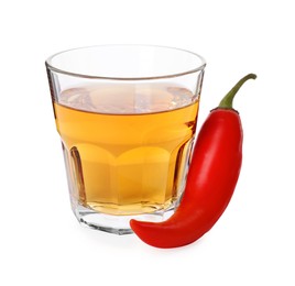 Red hot chili pepper and vodka in glass on white background