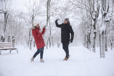 Photo of Happy couple having fun outside on winter day. Christmas vacation