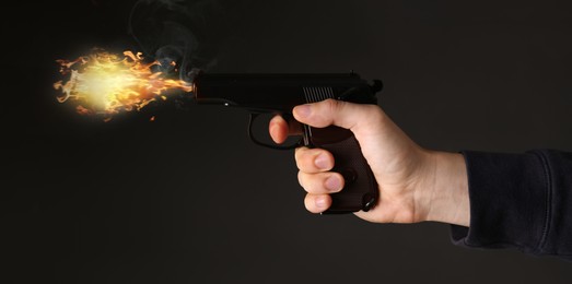 Man shooting handgun on black background, closeup. Banner design