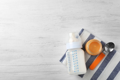 Flat lay composition with baby food and space for text on wooden background