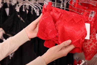 Woman choosing bra in lingerie store, closeup