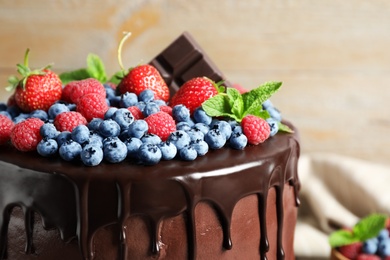 Delicious chocolate cake decorated with fresh berries, closeup