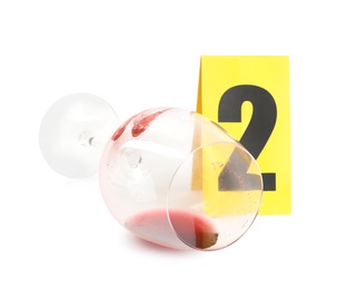 Photo of Wine glass with fingerprints and crime scene marker with number two isolated on white