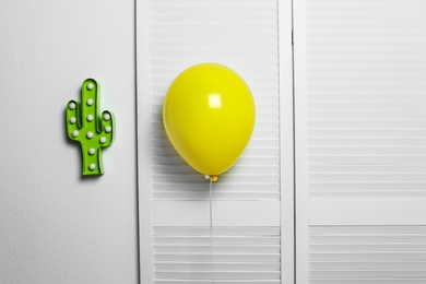 Yellow balloon on light background. Celebration time