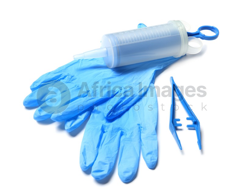 Medical gloves, disposable forceps and syringe on white background
