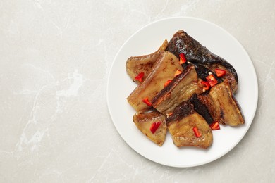 Photo of Tasty fried pork lard with pepper on light table, top view. Space for text