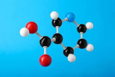 Photo of Molecule of vitamin B3 on light blue background. Chemical model