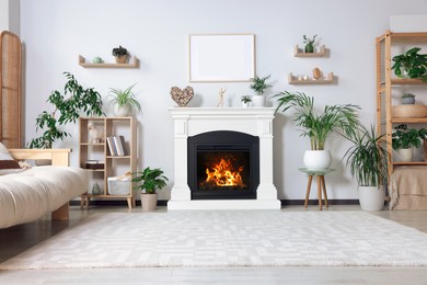 Photo of Stylish living room interior with fireplace, houseplants and beige sofa