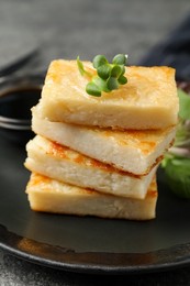 Delicious turnip cake with herbs served on grey table, closeup