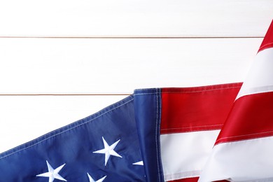 National flag of America and space for text on white wooden table, top view