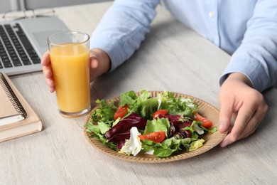 Photo of Office employee having business lunch at workplace, closeup