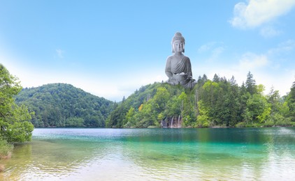 Majestic Buddha sculpture rising above picturesque mountains on sunny day 