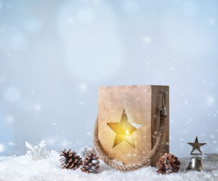Image of Composition with wooden Christmas lantern on snow against light grey background 