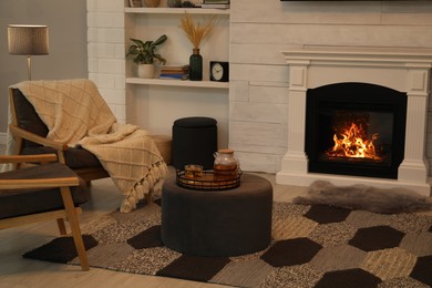 Cozy living room interior with comfortable armchairs and decorative fireplace