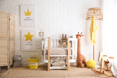 Photo of Baby room interior with toys and stylish furniture