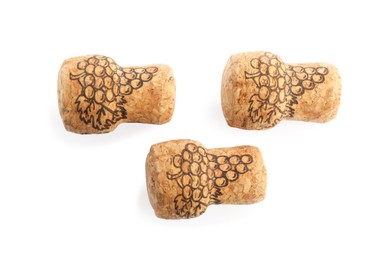 Sparkling wine corks with grape images on white background, top view