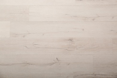 Light wooden laminate as background, top view. Floor covering