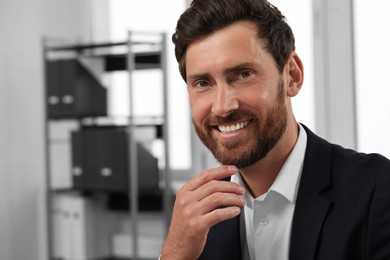 Portrait of smiling bearded man in office